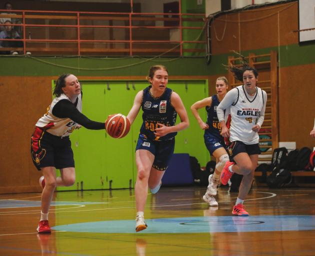 Southern Hoiho guard Olivia O’Neill takes the ball up the court as Mainland Pouakai defender Erin...