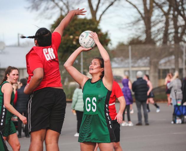 Maheno Green goal shoot Suzy Oakes is defended by Oamaru Men goal keep Andy Anderson during their...