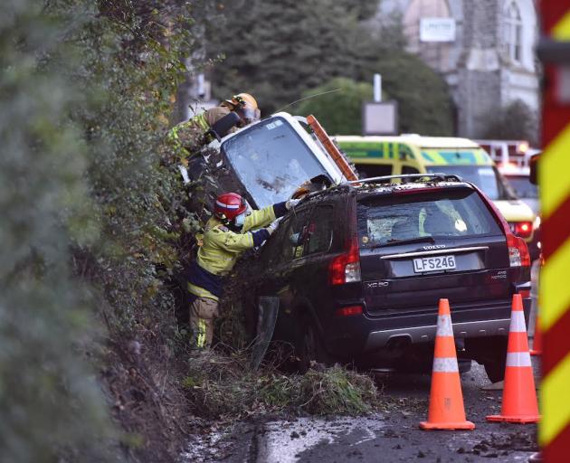 Fire crew work at the crash scene in Rattray St. Photo: Gregor Richardson