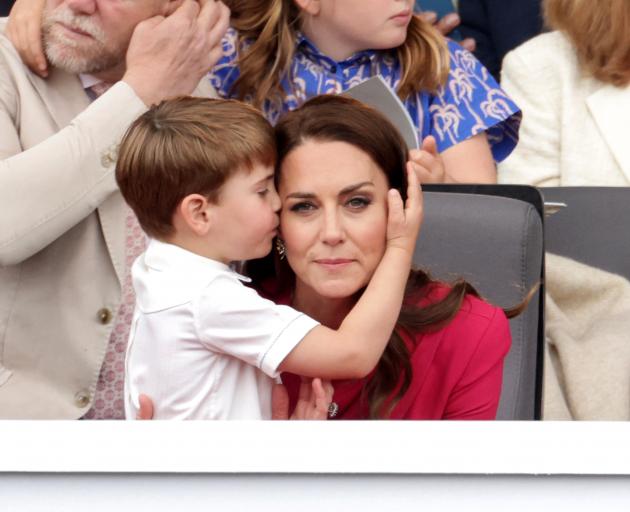 Prince Louis hugs his mother, Catherine, Duchess of Cambridge, during the Platinum Pageant in...
