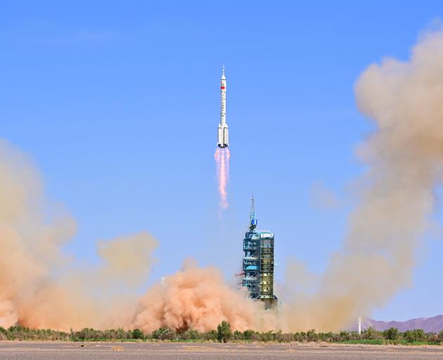 The Long March-2F carrier rocket, carrying the Shenzhou-14 spacecraft and three astronauts, takes...