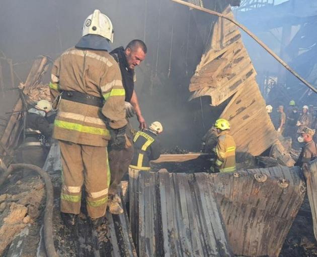 Rescuers work at a site of a destroyed shopping mall in Kremenchuk. Photo:  Press service of the...