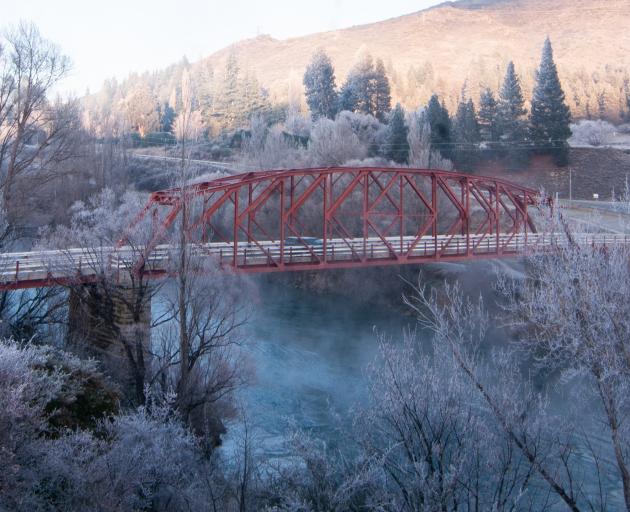 A car passes over Clyde’s red bridge in Central Otago in hoar frost conditions yesterday morning....