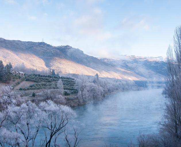 Mist hangs over the Clutha River looking towards the Clyde Dam in hoar frost conditions in Clyde.
