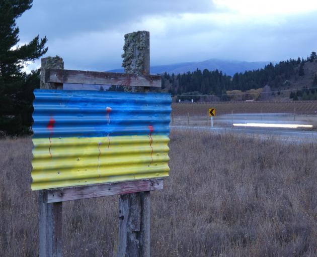 A makeshift sign bearing the colours of the Ukrainian flag has been repainted after it was...