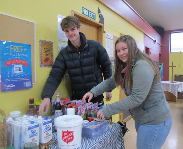 Dunstan High School pupils Kieran Boyd and Maria McKeen rearrange products at the Salvation Army...
