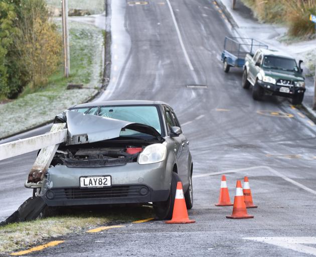A crashed car in icy conditions at the intersection of Orbell and Fea St, in Dunedin, yesterday...