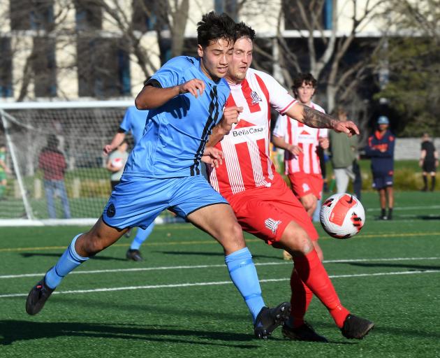 Royals player En Watanabe (left) and Queenstown’s Fredrik Ljungberg compete for the ball during...