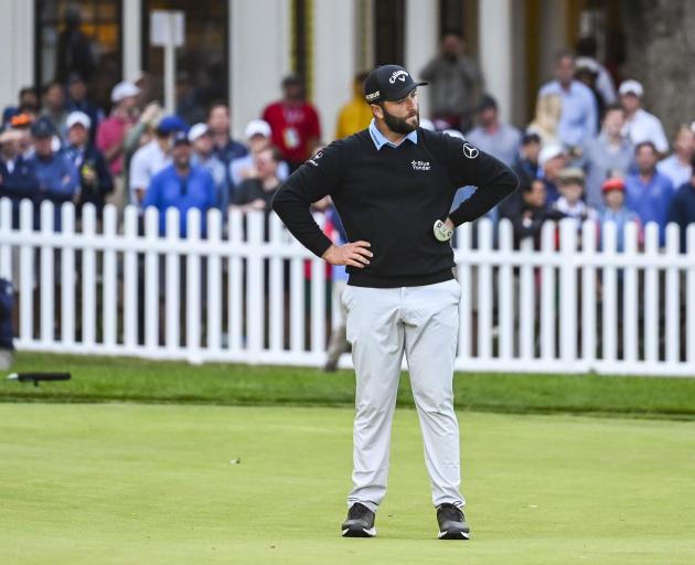 Defending US Open champion Jon Rahm double-bogeyed the 18th, giving up the outright lead. Photo:...