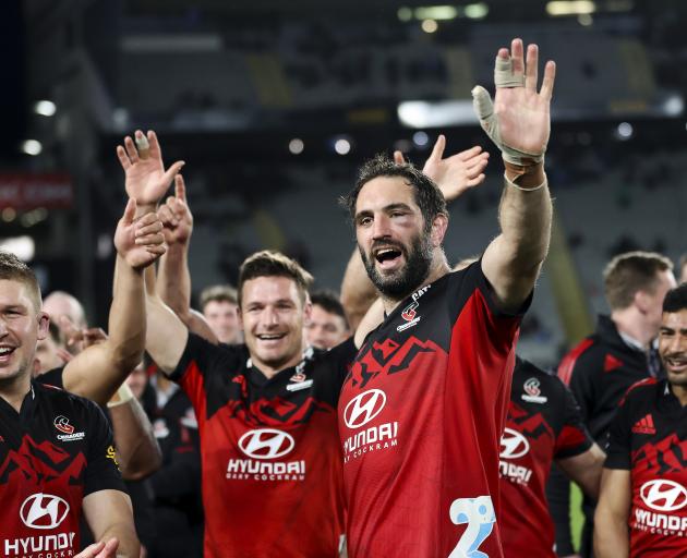 A bruised and battered Sam Whitelock celebrates after last night's Super Rugby Pacific final....