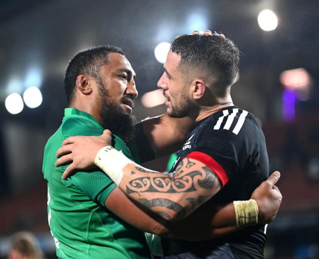 Ireland captain Bundee Aki (left) embraces opposition reserve halfback TJ Perenara.