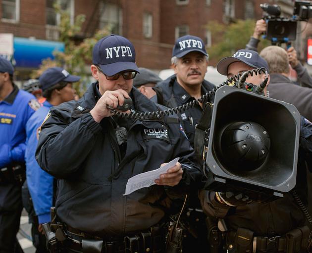 Members of the New York Police Department’s strategic response group use a long-range acoustic...