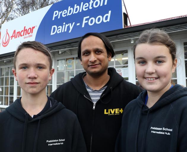 Prebbleton School head boy and girl, Kobie Ashby and Lily Hayston, with dairy owner Sam Mesta....
