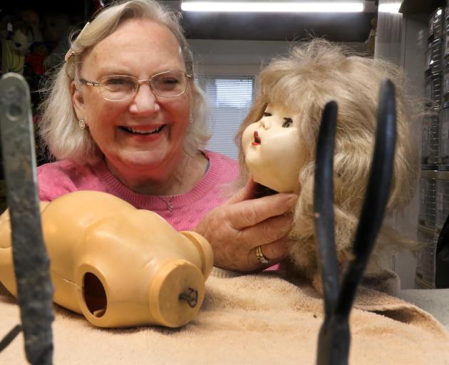 Joyce Reilly works on one of her favourite patients, a walkie talkie doll, at the Dolls City...