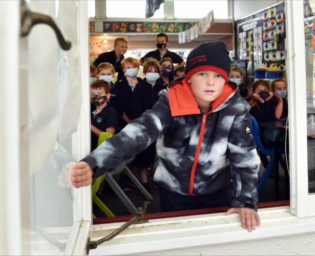 Maniototo Area School pupil Hugo Paterson (10) opens the window on a cold day to ventilate the...