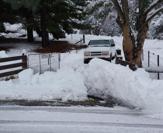 A snow drift left behind by snow ploughs blocks the driveway of Cardrona residents Martin and Kay...
