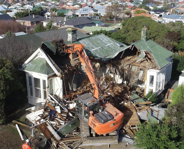 A digger demolishes the house earlier this month. PHOTOS: STEPHEN JAQUIERY