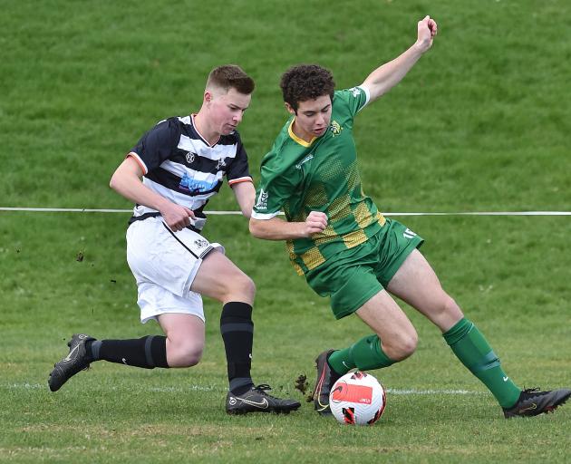 Northern’s Dean Allan (left) tries to win back possession from Green Island's Caleb Manson during...