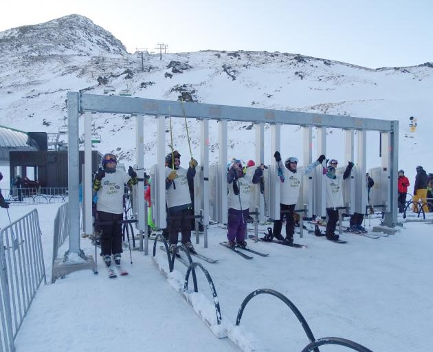 Skiers and snowboarders start lining up to be the first on the lift about 8am.
