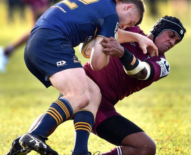 Dunedin second five Ben Shepherd is hauled down by Alhambra-Union opposite number Faketui Samuelu...