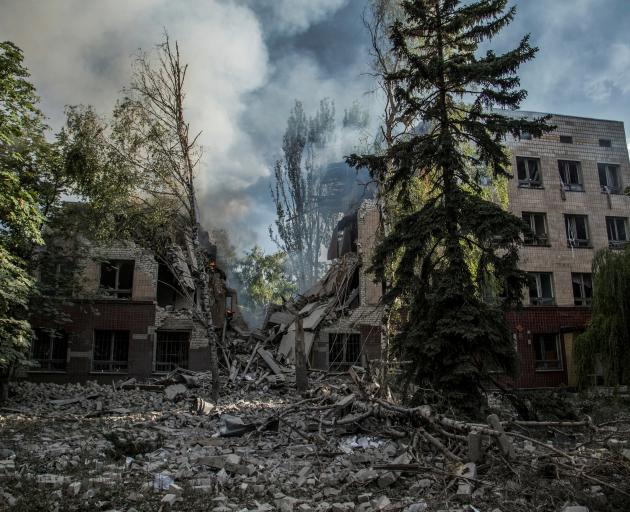 Smoke rises over the remains of a building destroyed by a military strike in Lysychansk recently....