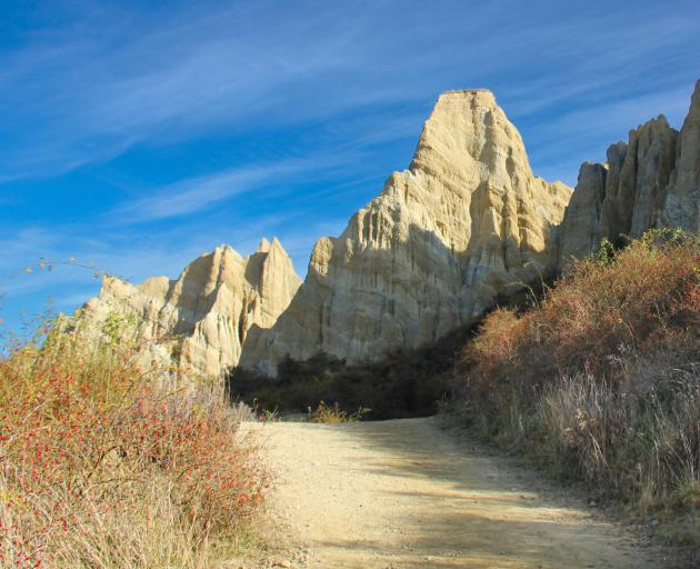 A well-formed path leads to the base of the cliffs.