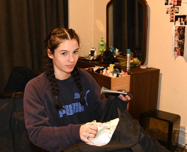 Aimee Clark packs a bag as she prepare to evacuate her Leith St Central flat last night. PHOTO:...