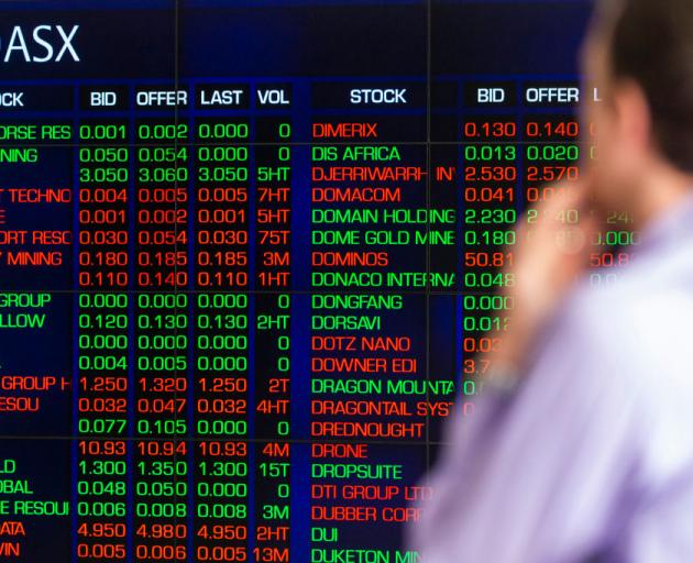 A man looks at the electronic display of stocks at the Australian Stock Exchange. Photo: Getty Images