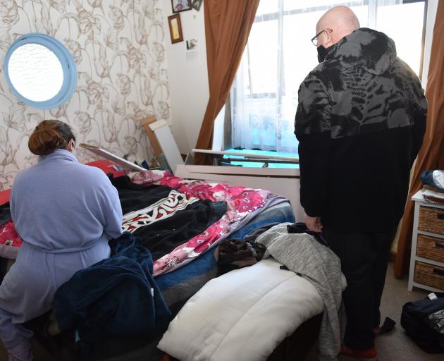 Megan Percy and Robert Allum look over the damage done to their Dunedin home after a car crashed...