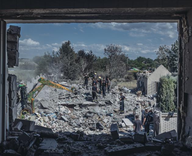 Emergency workers search for people under the rubble after the Russian shelling in Kramatorsk,...