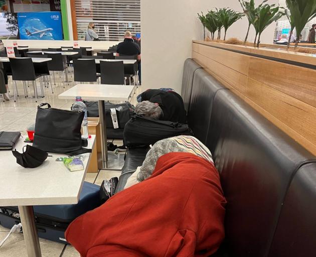 Passengers on the flight attempt to get some sleep in the airport. Photo: Supplied