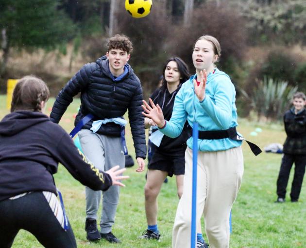 Lily Abbott goes for goal in a ki o rahi game while Logan Park team-mates Walid Ouhassine and...