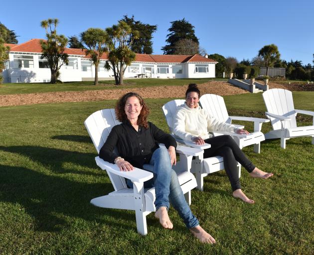 The Longhouse owner Ilse Erasmus (left) and team member Mariebelle Winters relax in front of the...