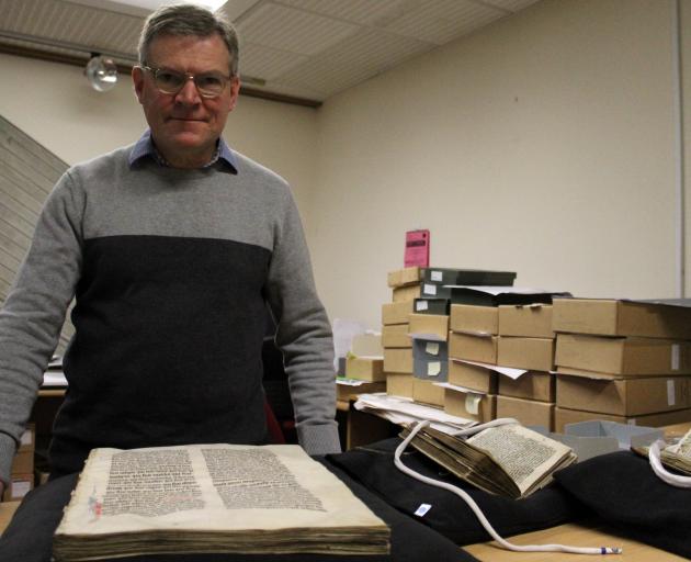 Reed rare books and special collections librarian Julian Smith shows some of the precious...