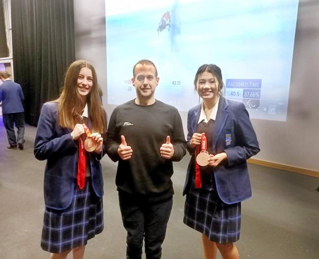 Winter Paralympic star Adam Hall with pupils Caitlin Stewart (left) and Jemma West at his former...