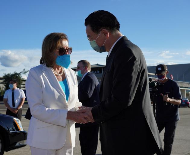 Nancy Pelosi talks with Taiwan's Foreign Minister Joseph Wu before boarding a plane for South...