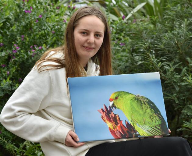 Holding up her award-winning photo of a Forbes' parakeet taken in the Chatham Island is Hazel...