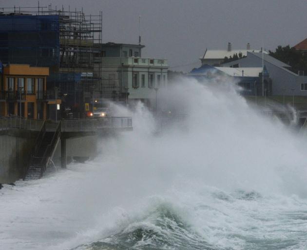 High seas lash cars driving on the St Clair Esplanade this afternoon. Photo: Gerard O'Brien