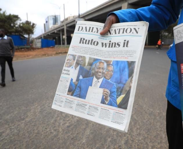 A newspaper vendor in Nairobi is seen selling a newspaper reporting on the win of Kenya Kwanza...