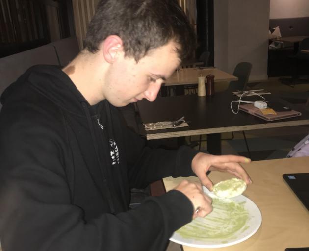 Team member Fred Sugden tests out the matcha powder on a senbei. Photo: Supplied