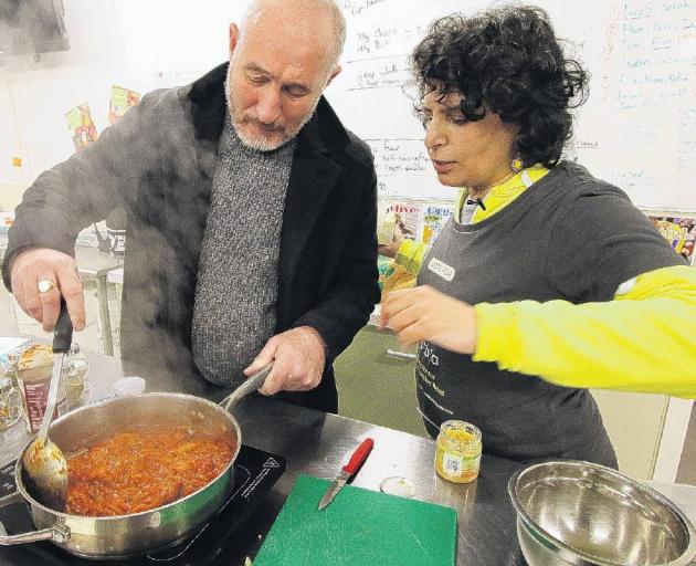 Padi Nistala guides Roger Menage on how to make a vegetable curry. PHOTO: JOHN COSGROVE