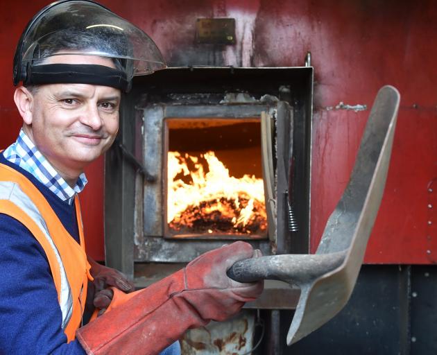 Climate Change Minister James Shaw mans a wood pellet burner, which has replaced a coal-fired...
