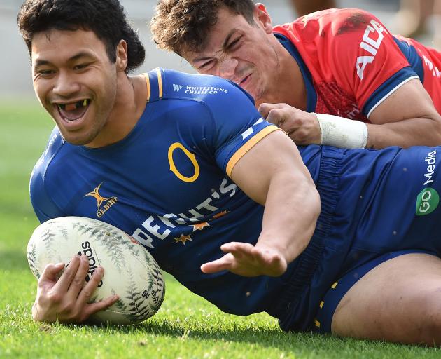 Raymond Nu’u scores a try for Otago as Tasman winger Macca Springer is left in his wake at...