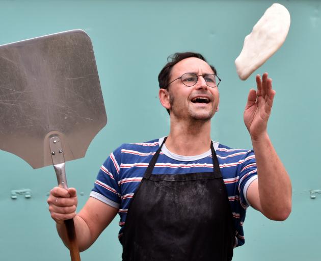 Slice of Heaven pizza caravan owner Gareth West prepares pizzas to go with borscht at his...
