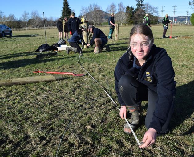 Taieri College pupil Catelyn Henderson (16), of Mosgiel, measures the correct distance to dig a...