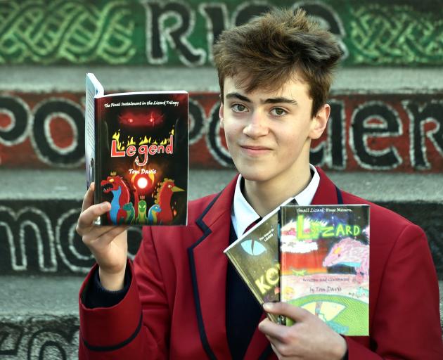 Kavanagh College pupil Tom Davis holds his trilogy of books at the school yesterday. PHOTO: PETER...
