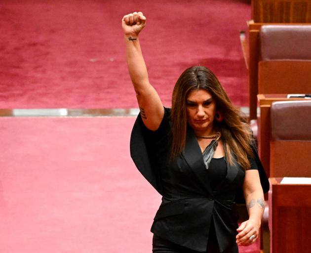 Indigenous Australian parliamentarian Lidia Thorpe raises her fist during her swearing-in...