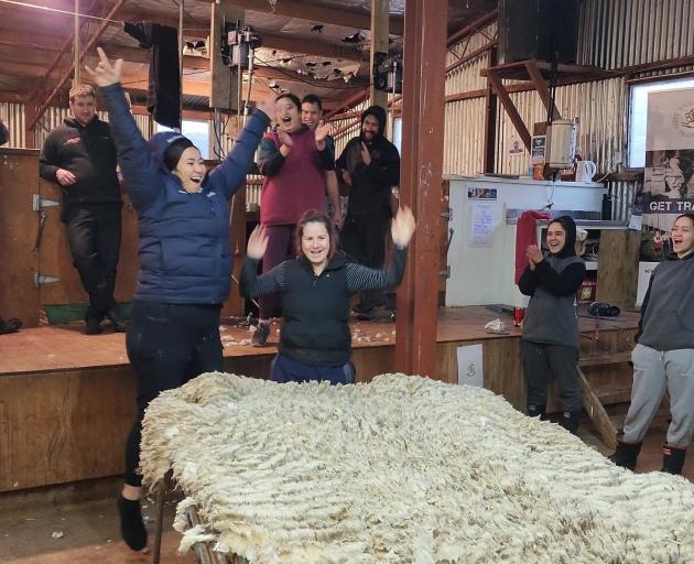 Woolhandling trainees are delighted by the perfection of a wool throw by a fellow trainee. PHOTO ...