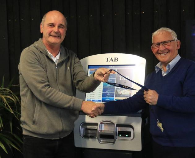Tony Music handing back the Addington Raceway keys to Christchurch Greyhound Racing Club...