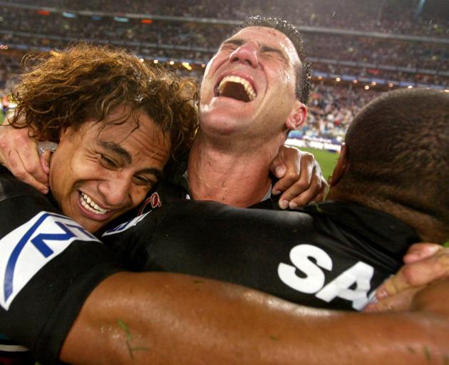 Sattler (centre) screams in delight as he embraces Penrith Panthers team-mates Joe Galuvao (left)...